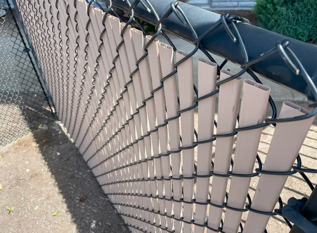 Chain-link fence with privacy slats for commercial property